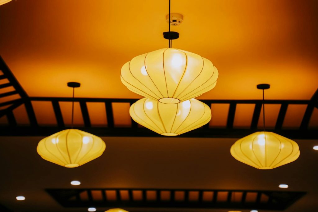 Elegant hanging lanterns with warm lighting create a cozy atmosphere indoors.